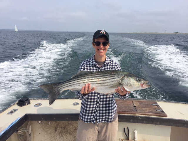Rachel Maddow holding a striper she caught on one of her many fishing charter excursions aboard the Beth Ann off of Provincetown, MA.
