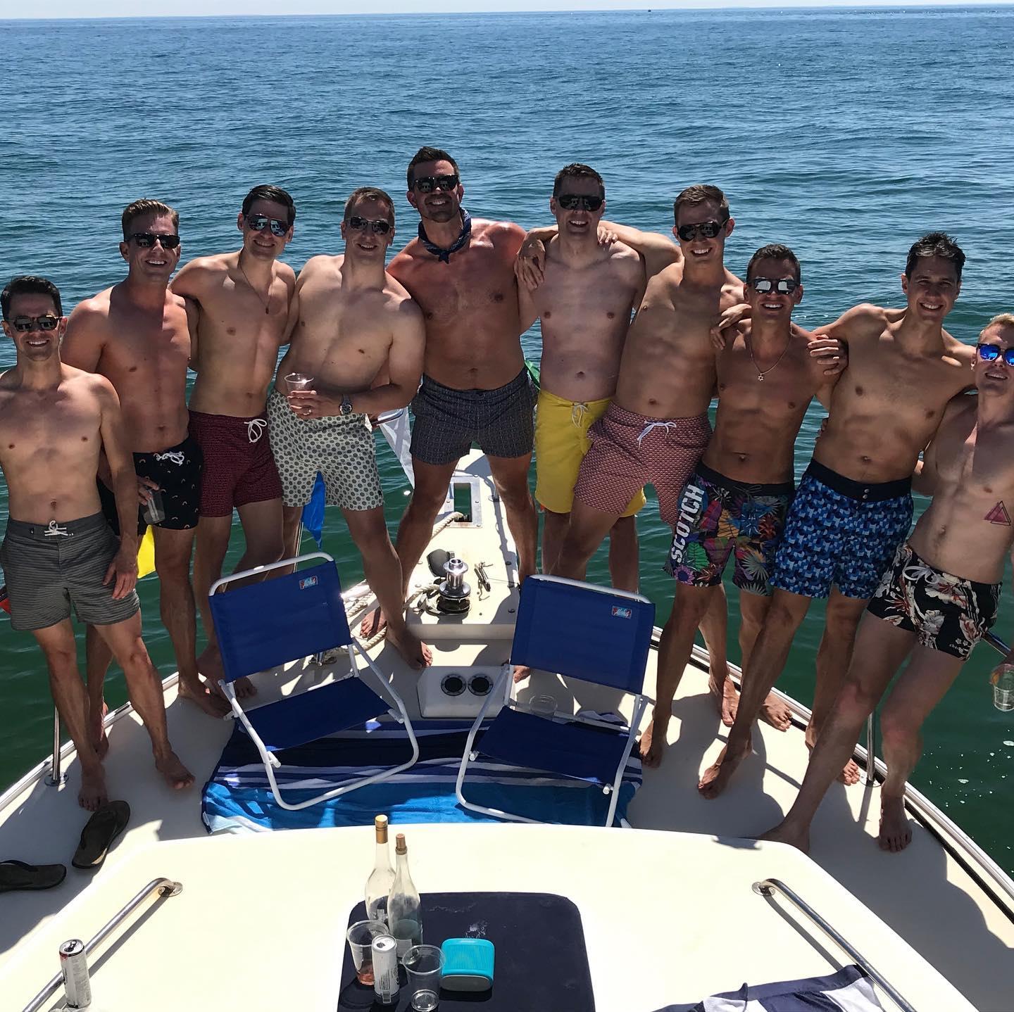 A group of buff men enjoying a Fun in the Sun cruise off of Race Point in Provincetown, Cape Cod..
