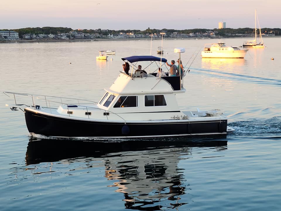 The Beth Ann cruising in Provincetown Harbor with passengers during a sunset trip