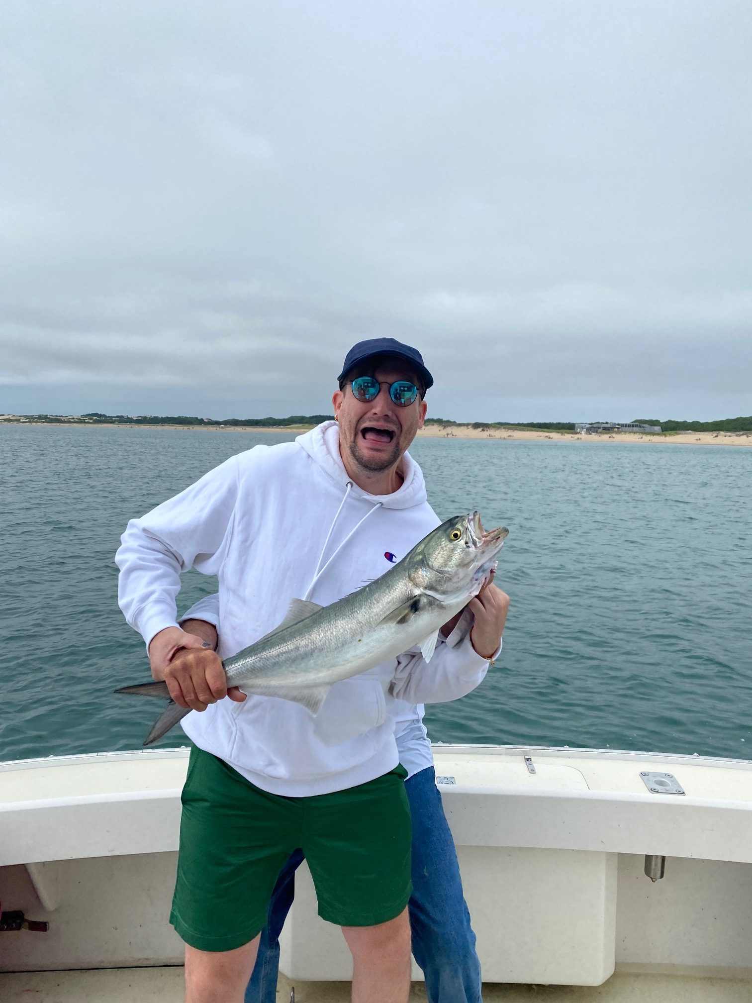Customer holding a fish caught on the Beth Ann of Race Point in Provincetown
