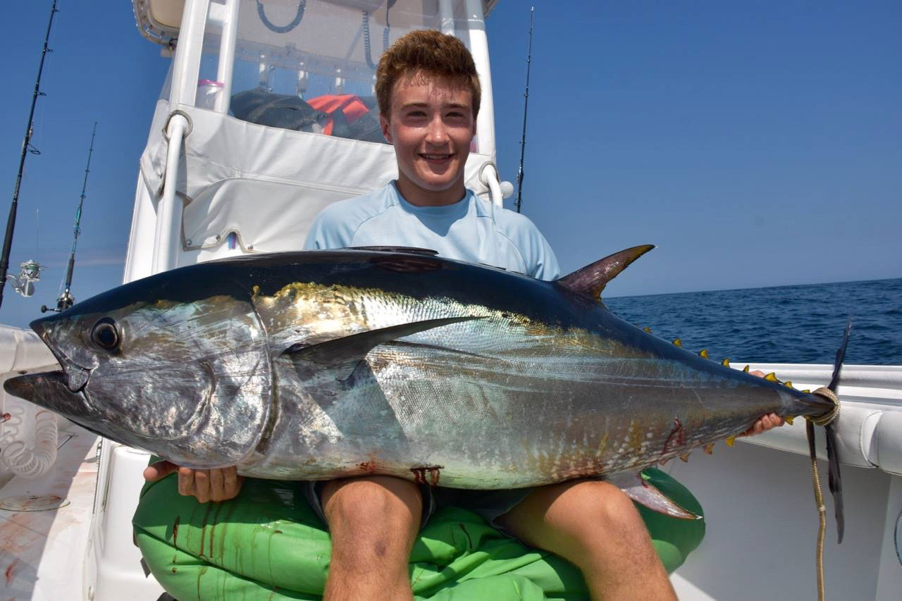 A boy holding a tuna caught off Provincetown Massachusetts