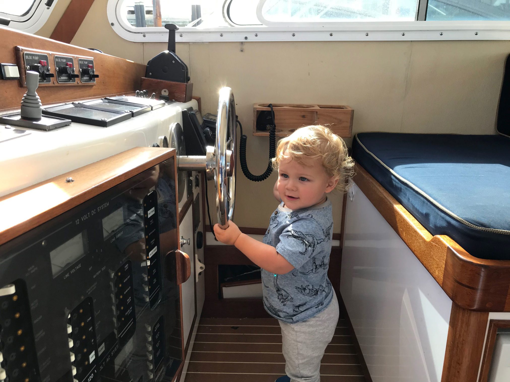 A young child at the wheel of the Beth Ann